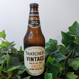 A bottle of Thatchers Vintage 2021 with leaves around it.